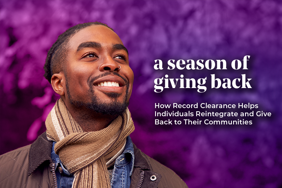 A smiling man wearing a scarf stands in front of a vibrant purple background, accompanied by the text: 'A season of giving back - How Record Clearance Helps Individuals Reintegrate and Give Back to Their Communities.